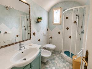 a bathroom with a sink and a toilet and a mirror at Casa al mare Porto Sole in Baja Sardinia +20 photos