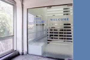 a window of a store with the words well come at FabHotel Blue Light in Mumbai +27 photos