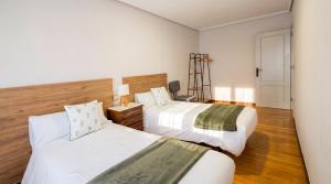 a hotel room with two beds and a ladder at Las Vistas in Suances