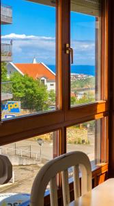 a view of the ocean from a window at Las Vistas in Suances