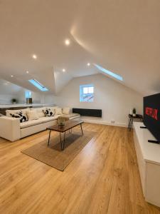 a living room with a couch and a table at Central duplex Apt in Leamington Spa in Leamington Spa
