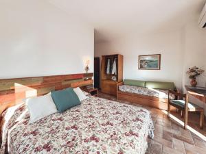a bedroom with a large bed and a desk at La Casa di Joy in Acquasparta +6 photos