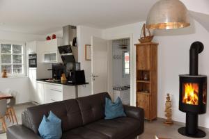 a living room with a couch and a fireplace at Ostseefeeling in Wustrow