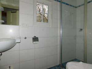 a bathroom with a shower and a sink at Puppenhaus in Ahrenshoop