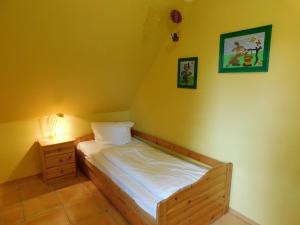 a small bedroom with a bed and a night stand at Haus Tina in Ahrenshoop