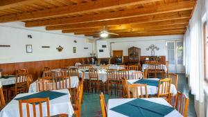 a restaurant with tables and chairs in a room at Tolcsvai Fogadó in Tolcsva