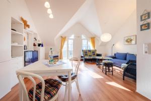 a kitchen and living room with a table and chairs at Hummer in Althagen