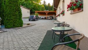 a row of tables and chairs next to a street at Tolcsvai Fogadó in Tolcsva