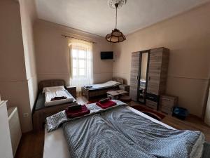 a room with two beds and a mirror in it at Tolcsvai Fogadó in Tolcsva