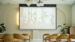 a large screen in a room with a bunch of chairs at Park Hotel Żywiec in Żywiec