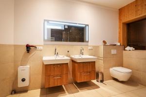 a bathroom with two sinks and a toilet at Suite Meeresrauschen in Ahrenshoop