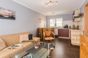 a living room with a couch and a table at Abendrot in Ahrenshoop