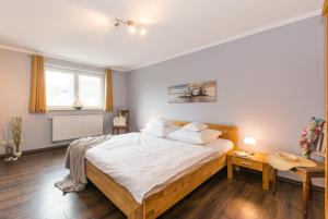 a bedroom with a large bed with white sheets and pillows at Abendrot in Ahrenshoop