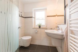 a bathroom with a toilet and a sink at Abendrot in Ahrenshoop