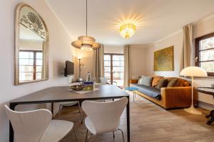 a living room with a table and chairs and a couch at Anker Haus Sanddorn in Althagen
