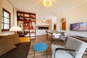 a living room with a couch and a table at Anker Haus Sanddorn in Althagen