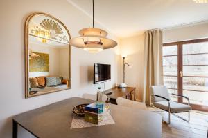 a living room with a table and a mirror at Anker Haus Sanddorn in Althagen +3 photos