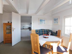 a dining room and kitchen with a table and chairs at Altes Backhaus 2 in Althagen