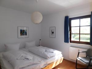 a white bed in a room with a window at Luv in Althagen