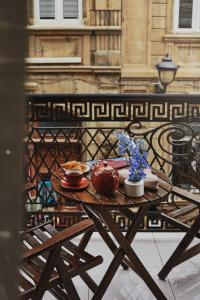 a wooden table with two bowls of food on it at Seven Rooms Boutique Hotel in Baku