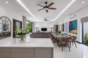 a kitchen and dining room with a ceiling fan at Exclusive Tropical Living! Elegant 4BR Villa Destiny with Salt Pool in Rawai Beach
