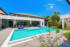 a swimming pool in front of a villa at Exclusive Tropical Living! Elegant 4BR Villa Destiny with Salt Pool in Rawai Beach