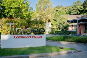 ein Schild für ein Golfresort vor einem Gebäude in der Unterkunft Tinidee Golf Resort Phuket in Kathu