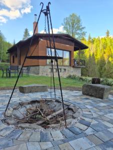 a fire pit in a yard with a building at Sarnówka KDN in Rajcza