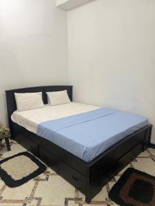 a bed in a bedroom with a blue mattress at Liora Villa in Negombo