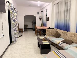 a living room with a couch and a table at Liora Villa in Negombo