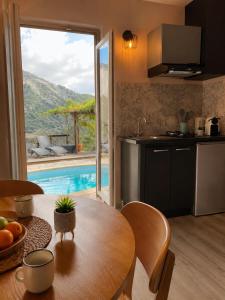 a kitchen and dining room with a table and a pool at Casa Versini in Balogna