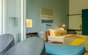 a bedroom with a bed and two chairs at Sonitori Boutique Resort in Phnom Penh