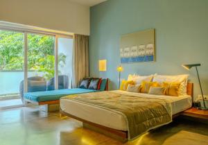 a bedroom with a large bed and a large window at Sonitori Boutique Resort in Phnom Penh