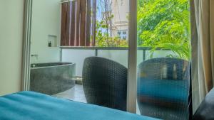 a room with two chairs and a window at Sonitori Boutique Resort in Phnom Penh +52 photos