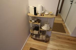 a small table with a coffee maker on top of it at Ostoja in Ojców