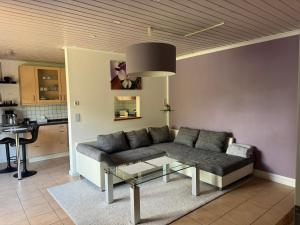 a living room with a couch and a table at Wohnung mit Gartenblick in Hofgeismar