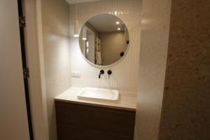 a bathroom with a sink and a mirror at Ostoja in Ojców
