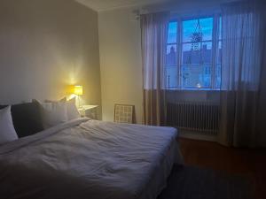 a bedroom with a large bed and a window at Våning Margareta in Kalmar