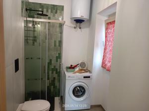 a bathroom with a washing machine and a shower at casa di Chiarina con parcheggio gratuito nel cortile privato in Binetto +106 photos