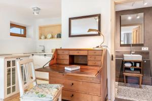 a bathroom with a wooden dresser and a mirror at Hofgut Heiligenberg in Heiligenberg +86 photos