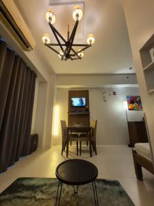 a dining room with a table and a chandelier at Tropical Escape at Pico De Loro in Nasugbu