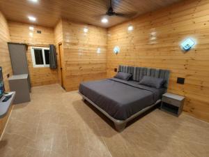 a bedroom with a bed in a wooden room at Mount Bliss Resort in Mhasla