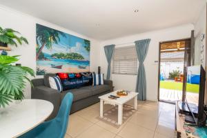 a living room with a couch and a table at Where Time Stops in Langebaan