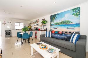 a living room with a couch and a table at Where Time Stops in Langebaan