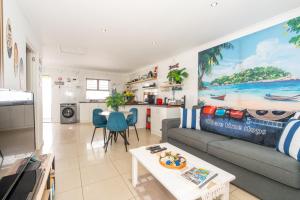 a living room with a couch and a table at Where Time Stops in Langebaan +13 photos
