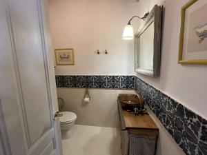 a bathroom with a toilet and a sink and a mirror at Apartamento Tana by SIERRA VIVA in Puerto-Gil
