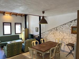 a living room with a table and a stone wall at Apartamento Tana by SIERRA VIVA in Puerto-Gil