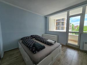 a bedroom with a bed with pillows on it at GOLD Residence in Sofia