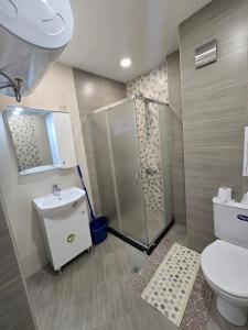 a bathroom with a shower and a toilet and a sink at GOLD Residence in Sofia