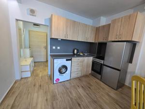 a kitchen with a washing machine and a dishwasher at GOLD Residence in Sofia